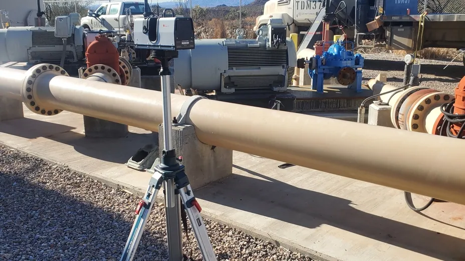 Artec long-range scanner on a tripod capturing pumps and pipework at a mine site